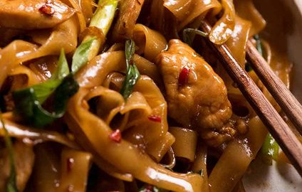 Close up of Thai Drunken Noodles with chopsticks
