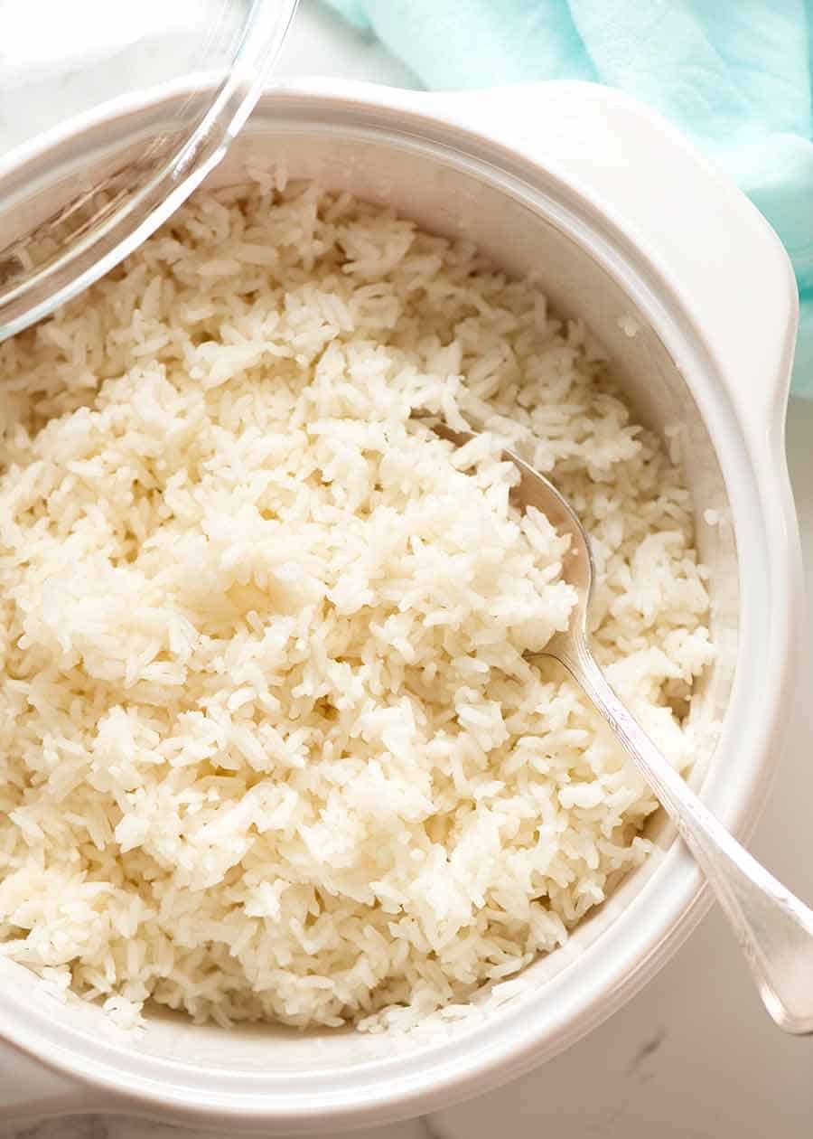 Photo of oven baked white rice in a casserole pot, fresh out of the oven ready to serve