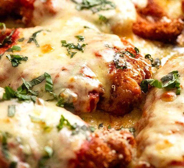 Close up of tray of Chicken Parmigiana (Chicken Parmesan), fresh out of the oven